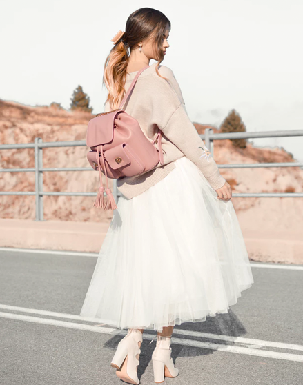 Woman in tulle skirt and backpack